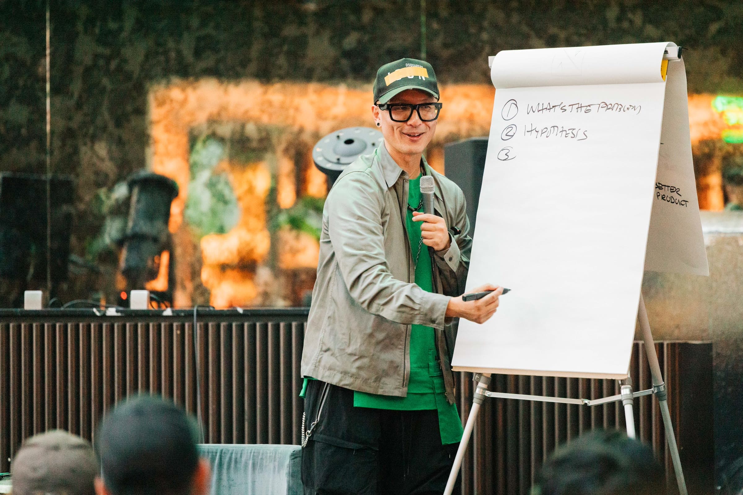 Chris Do teaching at a flip chart